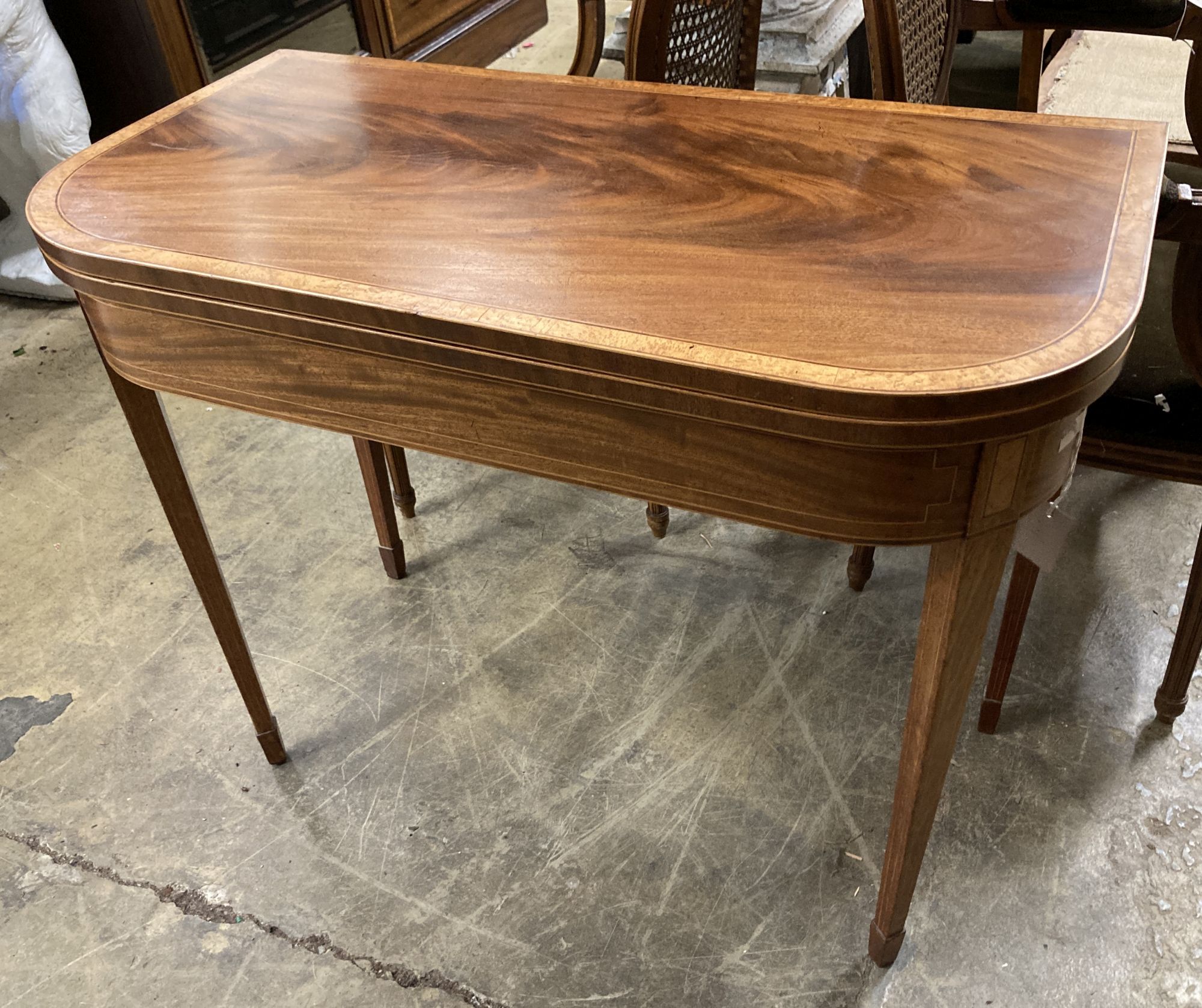 A George III bird's eye maple banded mahogany folding tea table, width 91cm, depth 46cm, height 75cm